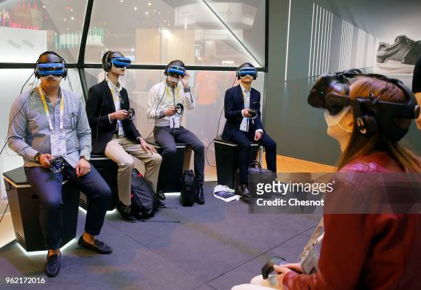 Visitors play a video game with the Acer Windows Mixed Reality Headset during the Viva Technologie show at Parc des Expositions Porte de Versailles...
