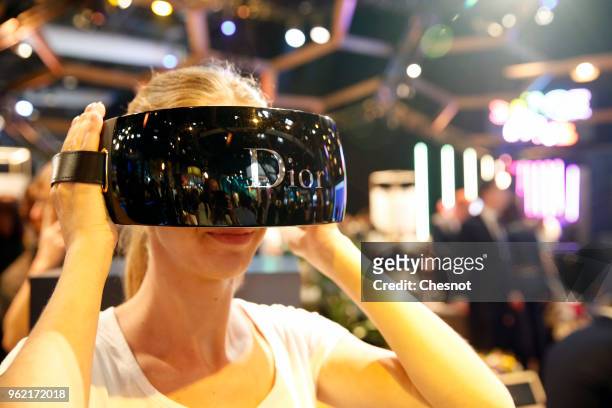 Woman wears a 'Dior eyes' virtual reality headset during the Viva Technologie show at Parc des Expositions Porte de Versailles on May 24, 2018 in...
