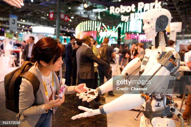 Visitor looks at a "Inmoov" humanoid robot during the Viva Technologie show at Parc des Expositions Porte de Versailles on May 24, 2018 in Paris,...
