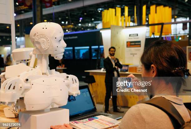 Visitor takes a picture with his smartphone of a "Inmoov" humanoid robot during the Viva Technologie show at Parc des Expositions Porte de Versailles...