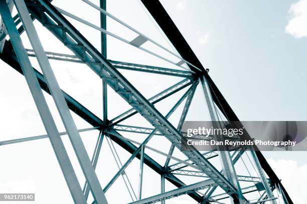 view of steel bridge against light sky - truss bridge stock pictures, royalty-free photos & images