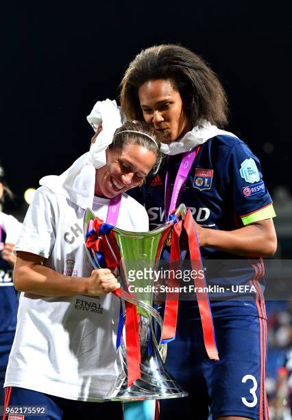 Camille Abily and Wendie Renard of Lyon celebrate with the trophy after the UEFA Womens Champions League Final between VfL Wolfsburg and Olympique...