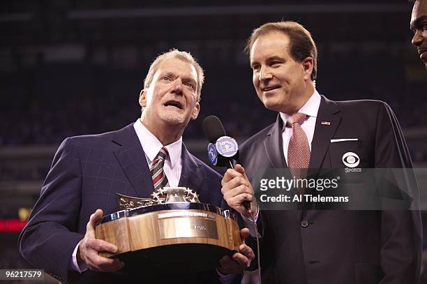 Playoffs: Indianapolis Colts owner Jim Irsay victorious with Lamar Hunt AFC Championship trophy and CBS annoncer Jim Nantz after winning game vs New...