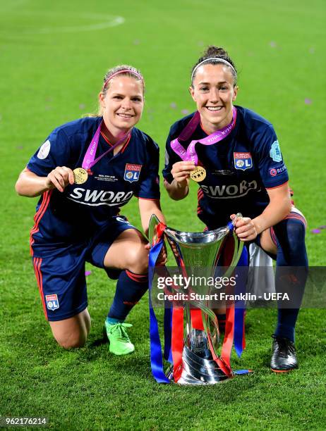 Eugenie Le Sommer and Lucy Bronze of Lyon celebrate with the trophy after the UEFA Womens Champions League Final between VfL Wolfsburg and Olympique...