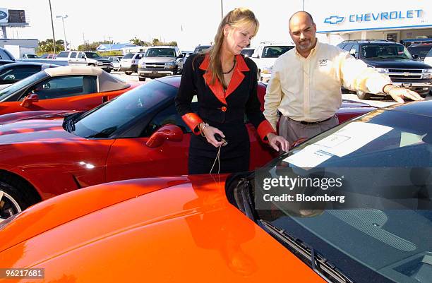 George Taylor escorts Karen Penrose through the selection of 2006 vehicles at Ed Morse Chevrolet in North Palm Beach, Florida, Thursday, November 10,...
