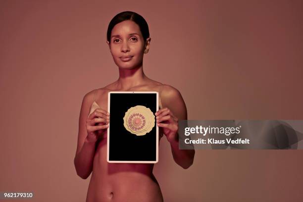 young woman holding tablet in front of breast - cancer portrait stock pictures, royalty-free photos & images