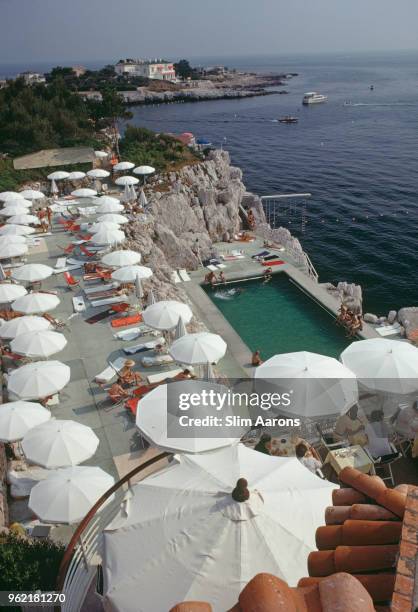 Guests round the swimming pool at the Hotel du Cap Eden-Roc, Antibes, France, August 1969.