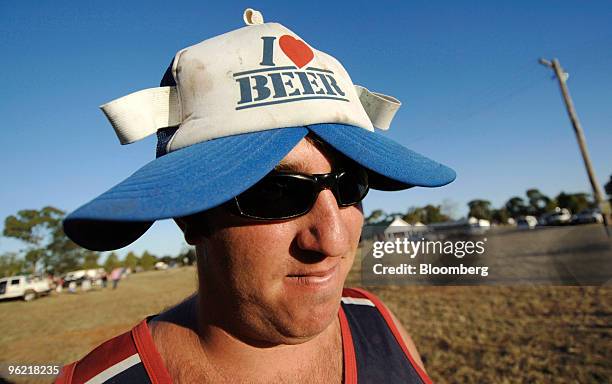 Reveler attending the Bachelor and Spinsters ball wears a hat claiming, "I Love Beer," in Trundle, Australia, on Saturday, March 1, 2008. With 48...