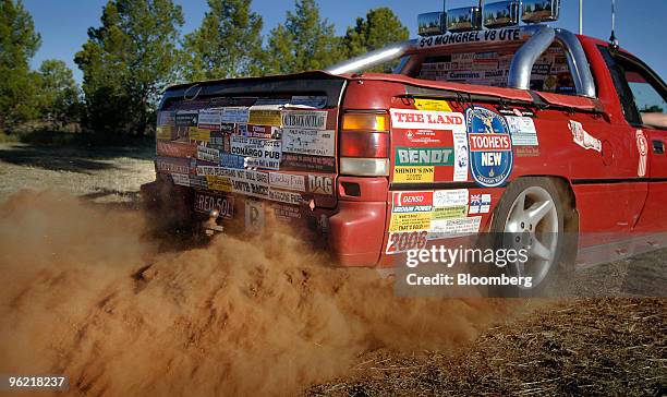 Pick-up truck covered with bumper stickers spins its wheels at the Bachelor and Spinsters ball in Trundle, Australia, on Saturday, March 1, 2008....
