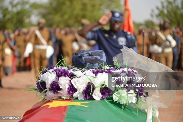 Burkina Faso's Gendarme stands guard in front of his colleague's coffin covered with the Burkina Faso's national flag and with a wreath of flowers...