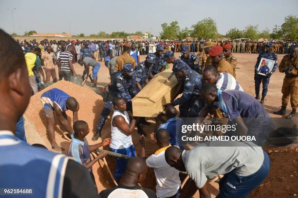 Burkina Faso's Gendarmes carry their colleague's coffin during the funeral ceremony on May 24, 2018 in Ouagadougou, following an operation to capture...
