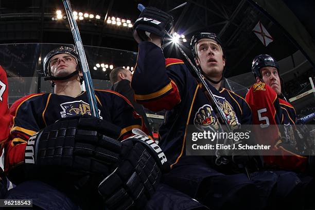 Michal Repik of the Florida Panthers sits on the bench with teammates Shawn Matthias and Bryan Allen while waiting for their next shift against the...