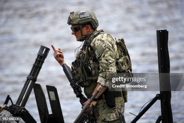 Navy Special Warfare Combatant-Craft Crewman stands aboard a Special Operations Craft Riverine boat after an International Special Operations Forces...