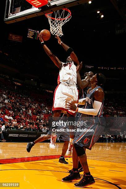 Jermaine O'Neal of the Miami Heat lays up a shot against DeSagana Diop and Gerald Wallace of the Charlotte Bobcats during the game on January 2, 2010...