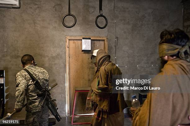 Two afghan villagers are seen blind fold as they are brought back to the outpost by US Army soldiers of B Company, 2nd Battalion,12th Infantry...