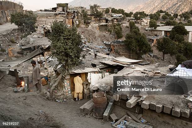 An Afghan worker is seen in front of his barrack at the "worker village" at the Korengal outpost on November 3, 2009 in the Korengal Valley, Kunar...