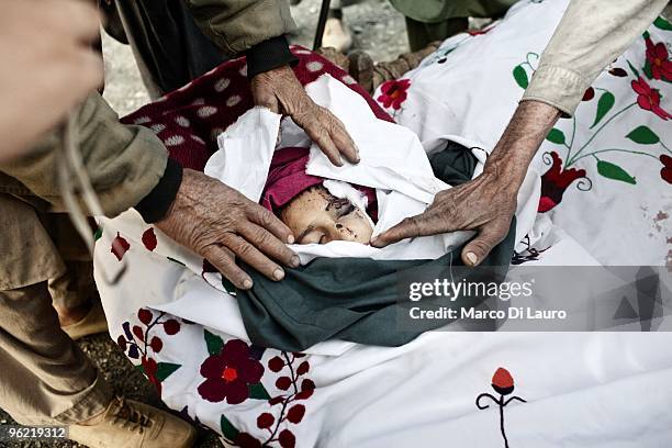The body of one of two children killed during an explosion is seen during his funeral as US Army soldiers of B Company, 2nd Battalion,12th Infantry...