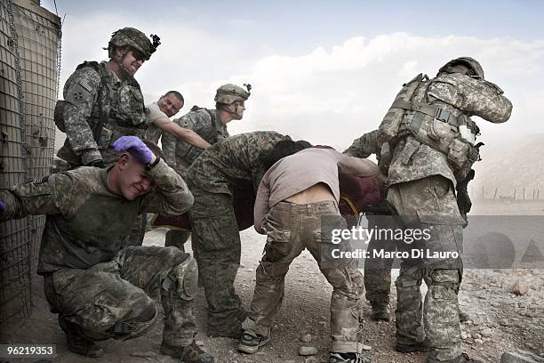 Army soldiers and medics of B Company, 2nd Battalion,12th Infantry Regiment, 4th Brigade,4th Infantry Division Baker Company shielded their eyes as a...