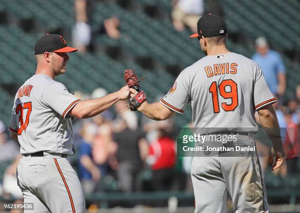 Dylan Bundy of the Baltimore Orioles is congratulated by Chris Davis after pitching for a complete game win against the Chicago White Sox at...