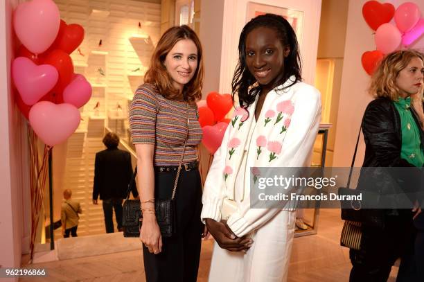 Melanie Bernier and Eye Haidara attend Roger Vivier "#LoveVivier" Book Launch Cocktail on May 24, 2018 in Paris, France.