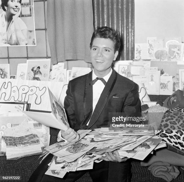 Cliff Richard in the dressing room at the Palladium, with cards for his 20th birthday. October 1960.