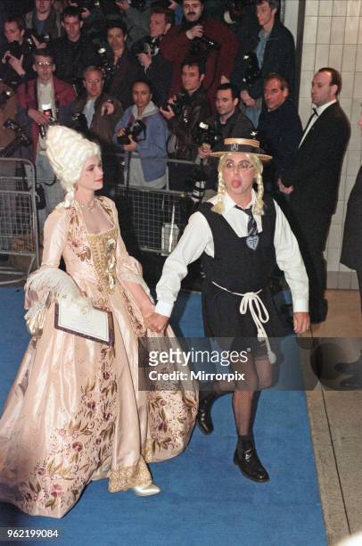 Roger Taylor, drummer for the rock band Queen, and guest arriving at Elton John's 50th birthday party at Hammersmith Palais, 6th April 1997.