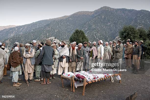 Two makeshift stretcher with the bodies of two children killed during an explosion are seen during their funeral as US Army soldiers of B Company,...