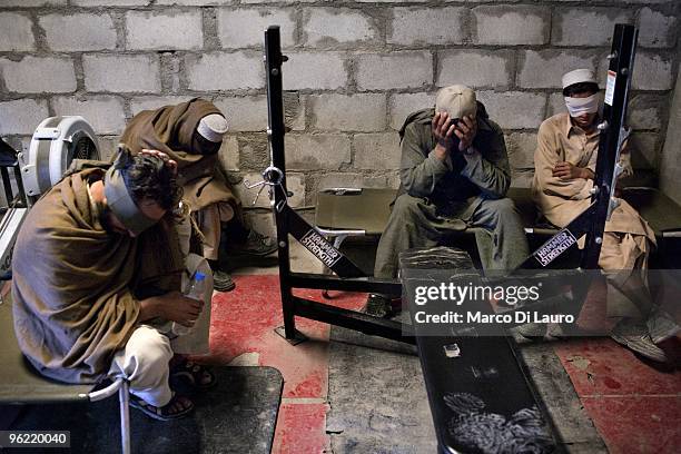 Two afghan villagers are seen blind fold as they are brought back to the outpost by US Army soldiers of B Company, 2nd Battalion,12th Infantry...
