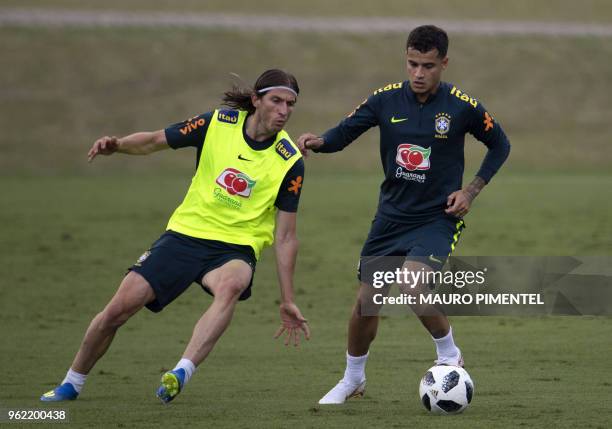 Brazil's players Filipe Luis and Philippe Coutinho vie for the ball during a training session of the national football team ahead of FIFA's 2018...