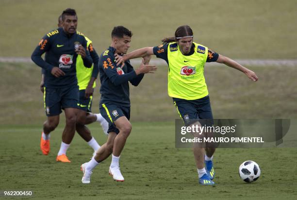 Brazil's players Filipe Luis and Philippe Coutinho vie for the ball during a training session of the national football team ahead of FIFA's 2018...