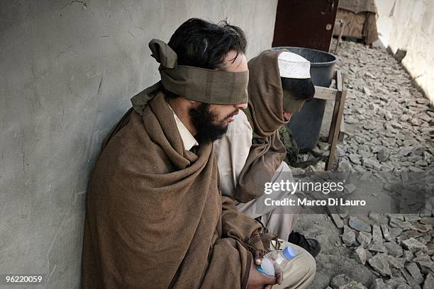 Two afghan villagers are seen blind fold as they are brought back to the outpost by US Army soldiers of B Company, 2nd Battalion,12th Infantry...