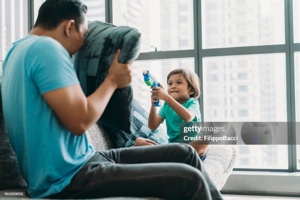 Malaysian dad playing with his child