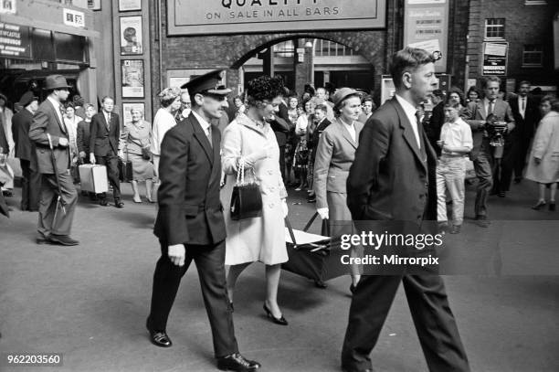 Katharine, Duchess of Kent, carrying her baby in a carry cot with the aid of the nurse left the train from York at Kings Cross, almost unnoticed by...