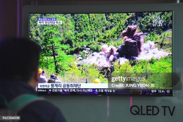 People watch a television news showing a picture of the dismantling of North Korea's Punggye-ri nuclear test site, at a railway station in Seoul on...