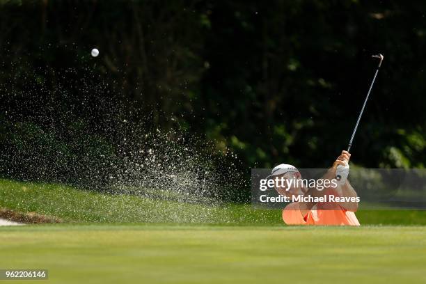 Justin Rose of England plays a shot from a bunker on the 11th hole during round one of the Fort Worth Invitational at Colonial Country Club on May...