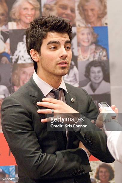 Joe Jonas speaks with a reporter during the Eunice Kennedy Shriver Act support reception at the Hart Building on January 27, 2010 in Washington, DC.