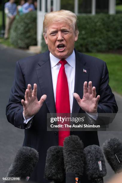 President Donald Trump talks to journalists before departing the White House on May 23, 2018 in Washington, DC. Trump is traveling to New York where...