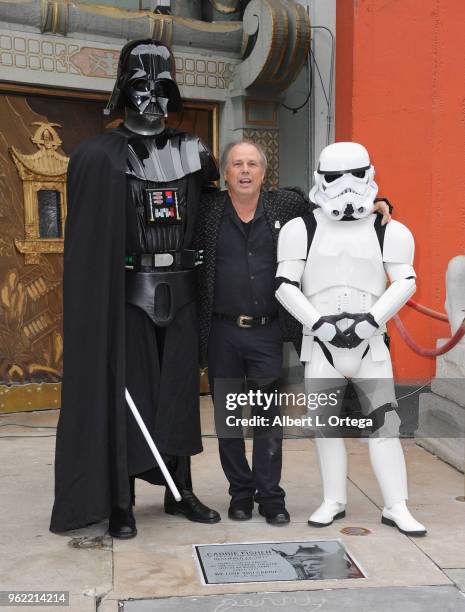 Todd Fisher, Darth Vader and a Storm Trooper pose beside the etched granite plaque for the late Carrie Fisher, unveiled in front of the TCL Chinese...