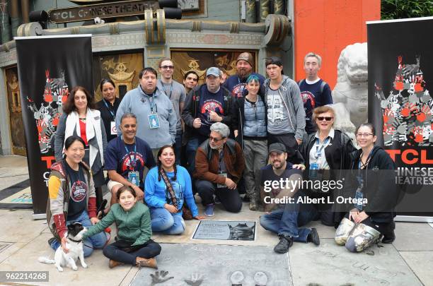 Members of Liningup.net pose beside the etched granite plaque for the late Carrie Fisher, unveiled in front of the TCL Chinese Theater on May 24,...