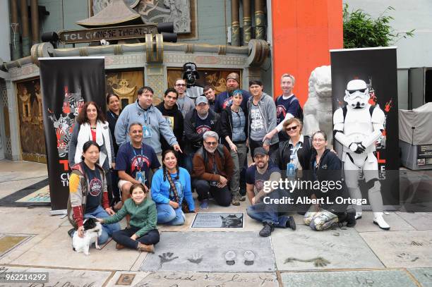 Members of Liningup.net pose beside the etched granite plaque for the late Carrie Fisher, unveiled in front of the TCL Chinese Theater on May 24,...