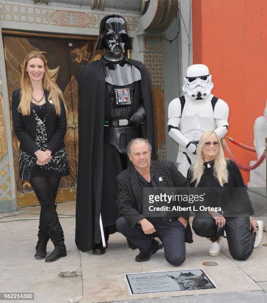 Todd Fisher poses with Alwyn Hight Kushner, president and COO of the TCL Chinese Theater, Darth Vader and a Storm Trooper, beside the etched granite...