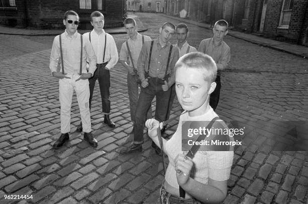 Seventeen year old skinhead teenager Janet Askham poses with her friends at her home in Huddersfield, West Riding of Yorkshire, 6th June 1970.