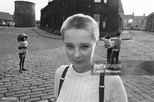 Seventeen year old skinhead teenager Janet Askham poses in the street at her home in Huddersfield, West Riding of Yorkshire, 6th June 1970.