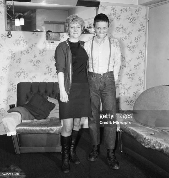 Fifteen year old skinhead Chris Harward poses at home with his mother Joan at their flat in Streatham, South London, 10th April 1970.