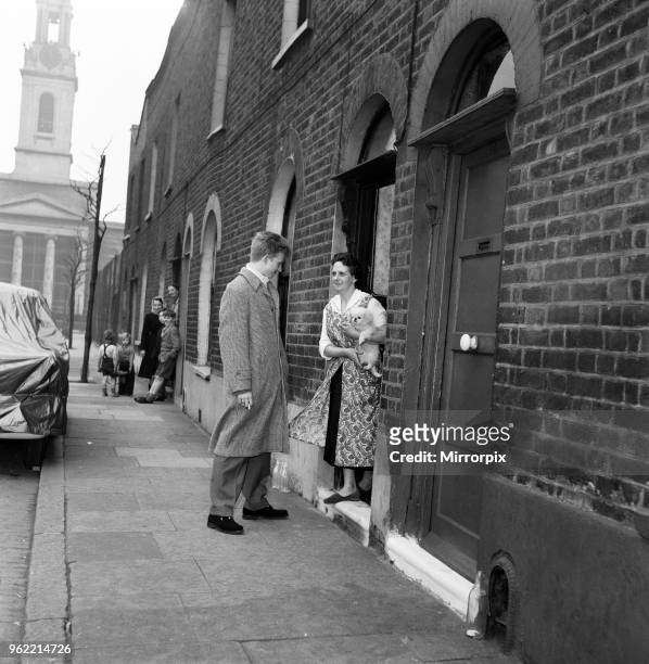 Singer and actor Tommy Steele says goodbye to his mother outside their home in Bermondsey, London, to go to Cafe de Paris, 22nd January 1957.