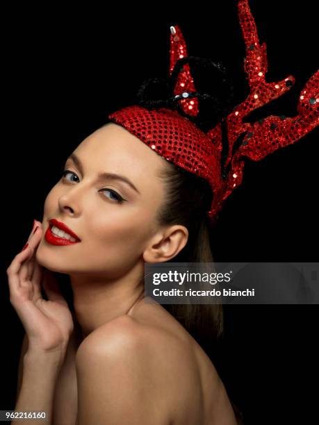 portrait_of_brunette woman with red fashion paillettes crown red lipstick and red nail polish - thin lips stock pictures, royalty-free photos & images