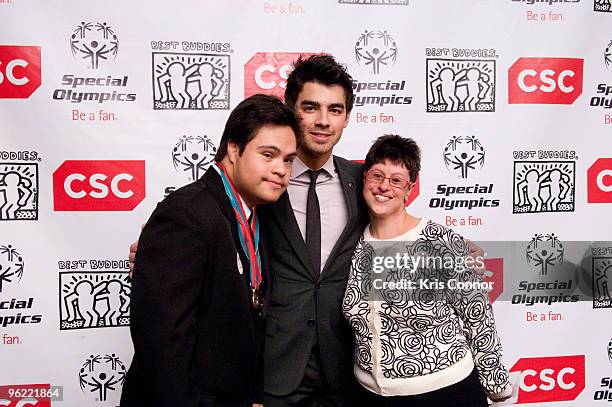 Carlos Sierra, singer Joe Jonas and Rachel Lipke pose for a photo before the Eunice Kennedy Shriver Act support reception at the Hart Building on...