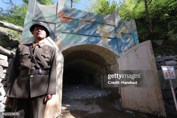 In this handout image provided by the News1-Dong-A Ilbo, a North Korean soldier stands at the entrance to a tunnel at the Punggye-ri nuclear test...