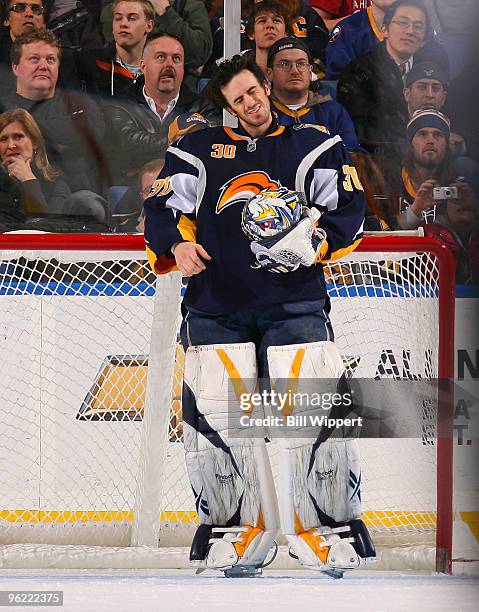 Ryan Miller of the Buffalo Sabres stretches his neck after being involved in a third period collision against the New Jersey Devils on January 27,...