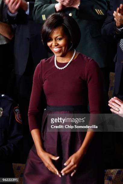 First lady Michelle Obama looks on before her husband U.S. President Barack Obama's speech to both houses of Congress during his first State of the...